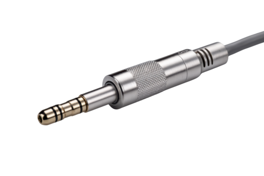 Close up of silver audio jack connector with gold tip on black background plug metal