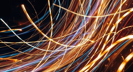 Abstract light trails in motion with orange and blue streaks on dark background