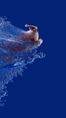 Santa Claus in dynamic splash of water against deep blue background, creating festive and energetic scene. vibrant colors and motion convey excitement and holiday cheer