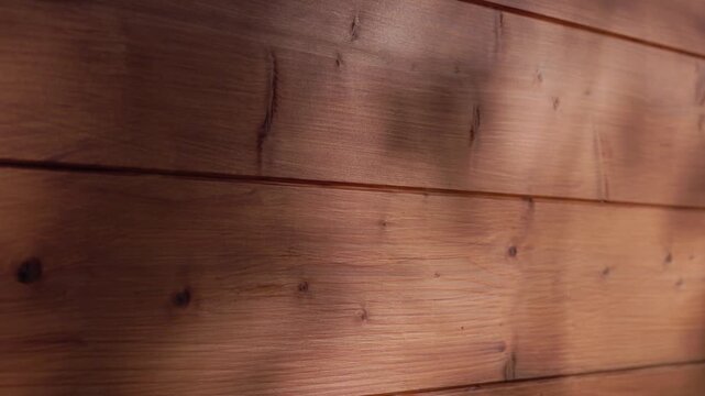 Close-up brown stained wood background with rich grain and soft light, seamless texture ideal for text overlays and design backdrops.