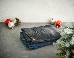 A stylish display of various washed denim jeans hanging on a metal grid rack, showcasing different textures, colors, and modern casual fashion details.