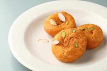 Fresh hot Badusha served with garnished nuts, popular cultural Indian dessert