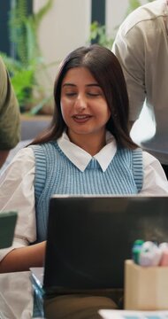 Business, conversation and woman with teamwork, laptop and feedback with creative project. Employees, magazine editor and journalist in office, pc and submission with publication, talk or cooperation