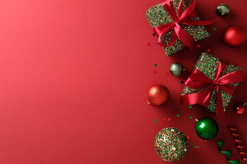 Christmas gift boxes and ornaments border on the right of a vibrant red background.