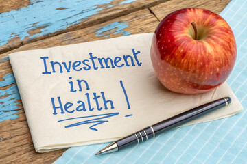 Health Motivation Concept with Red Apple and Handwritten Note – Investment in Wellness and Lifestyle Message