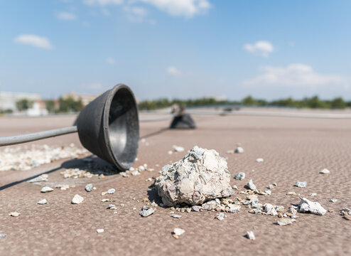 Poor-quality concrete fell from lightning rod weight supports on the rooftop of the building