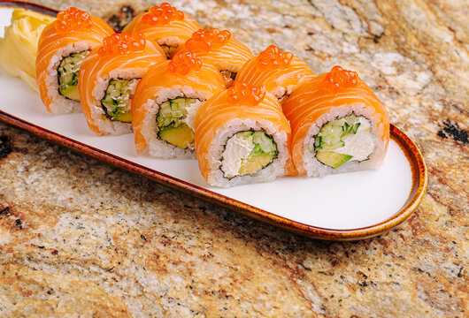 Delicious sushi rolls with salmon and avocado on a stylish plate