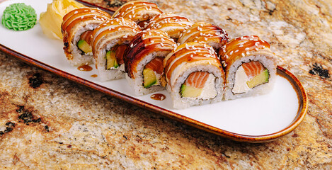 Delicious sushi rolls served on a marble tabletop garnished with wasabi