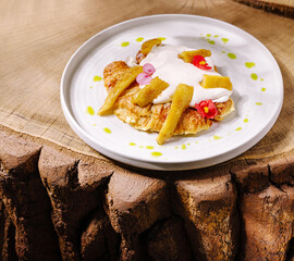 Delicious dessert featuring fresh fruits and cream on a wooden table
