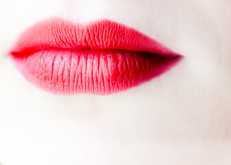 Close-up of a person's lips with red lipstick
