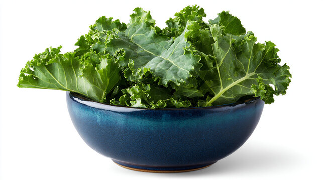 A blue ceramic bowl filled with fresh green kale leaves sitting on a white surface in a studio shot - Powered by Adobe