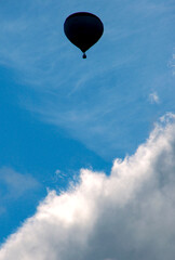 A hot air balloon floats in the sky.