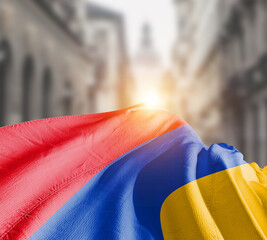 Armenia flag fluttering on blur street with building. Armenia national flag for independence day.