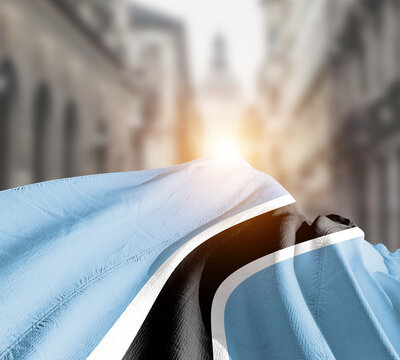 Botswana flag fluttering on blur street with building. Botswana national flag for independence day.