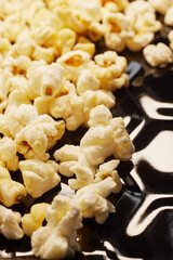 Close-up of fresh popcorn on a black baking tray
