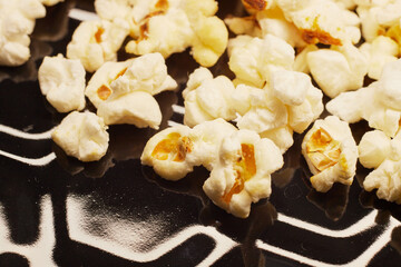 Close-up of fresh popcorn on a black baking tray