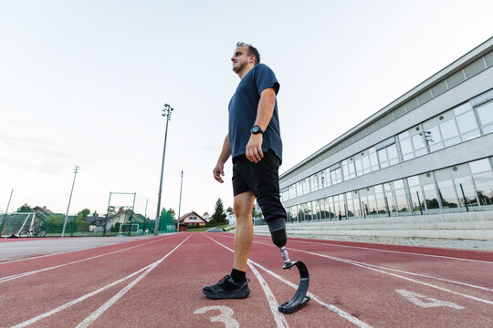 Male athlete running safely and confidently using a transtibial prosthesis with a sports blade and enjoying an active life.