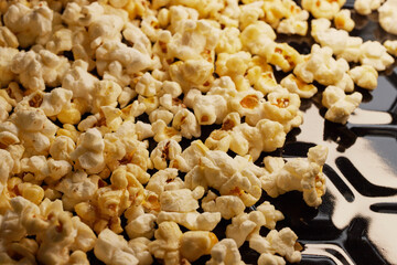 Close-up of fresh popcorn on a black baking tray
