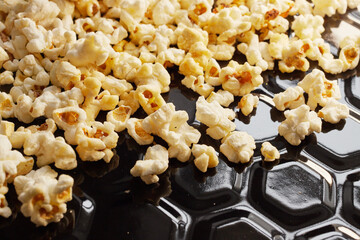 Close-up of fresh popcorn on a black baking tray