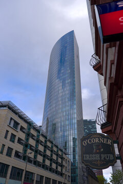 Looking up Skyper glass tower named Skyper at downtown of German city of Frankfurt on a cloudy autumn day. Photo taken November 3rd, 2025, Frankfurt am Main, Germany.