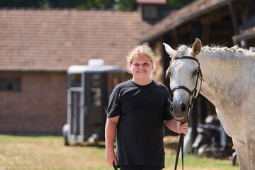 Girl with her horse in the countryside, a young rider and her equine friend, outdoor scene with...