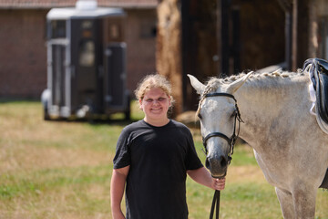 Girl with her horse in the countryside, a young rider and her equine friend, outdoor scene with...