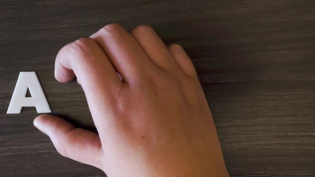 the word autism written on a dark background with white block letters or capital letters