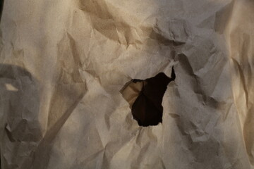 crumpled paper cardboard texture in the center a hole for text copy space,