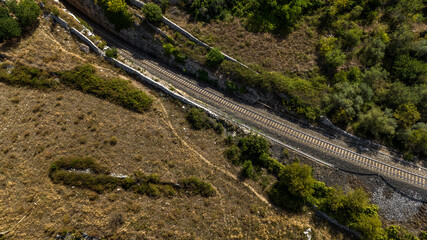 Fototapeta premium Aerial view of a railroad tracks crossing the countryside.