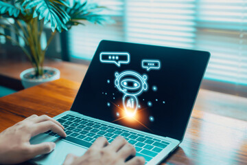 A person typing on a laptop with a virtual AI chatbot icon displayed on the screen, symbolizing intelligent conversation, automated support, digital assistance, and modern artificial intelligence