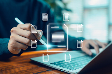 A person using a digital pen to manage and organize electronic documents on a laptop, representing digital file management, cloud documents, workflow organization, and modern online document systems.