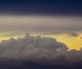 Colorful sunset sky glowing behind textured clouds in a serene atmosphere