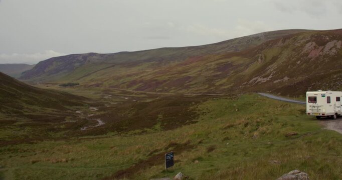 Slow zoom wide shot Looking down the A93 old military Rd to Glenshee at Devil&rsquo;s Elbow Viewpoint, Blairgowrie, with campervan