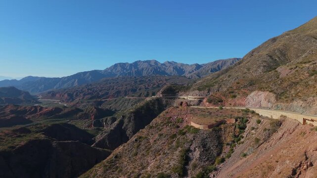 Cuesta de Miranda mountain road winds through colorful hills along Ruta 40, near Chilecito, La Rioja, Argentina.