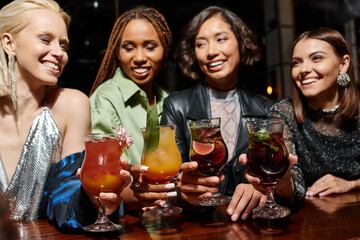 Friends share joyful moments while celebrating at a lively party with colorful drinks