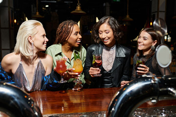 Joyful friends celebrate at a vibrant party with colorful cocktails in a lively bar scene