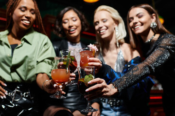 Friends gathered at a vibrant party celebrating friendship with laughter and delicious drinks