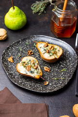 Baked pear with blue cheese, honey, and nuts. Healthy eating. Vegetarian food.