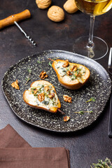 Baked pear with blue cheese, honey, and nuts. Healthy eating. Vegetarian food.