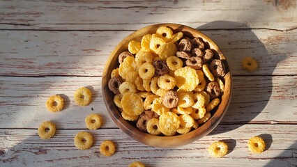 Bowl of cereal rings on wooden table