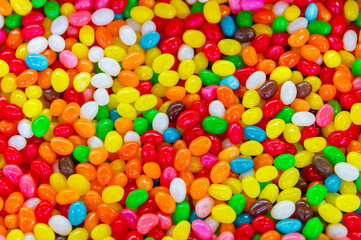 Colorful background of multicolored, shiny, round, chewy candies. A background photo of colorful sweets. A close-up photo of the candies taken in a candy store