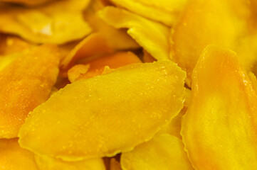 Dried mango in abundance. Top view, close-up, flat pack. Healthy eating and minimalism, dehydrated product