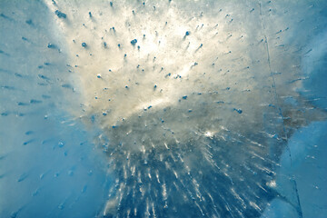 A celestial blue ice, with air bubbles and a glimmering light.