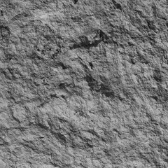A concrete wall covered with paint with a texture of defects and cracks