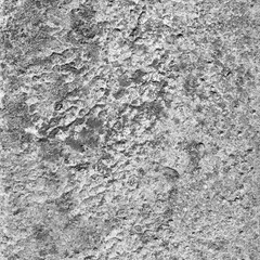 A concrete wall covered with paint with a texture of defects and cracks
