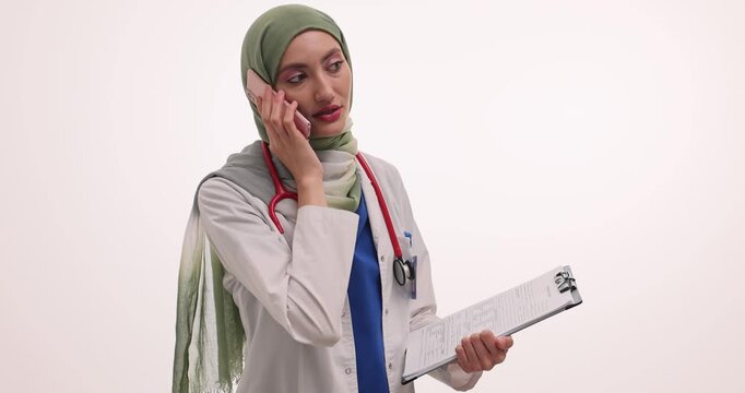 Doctor in hijab explains test results to patient over call on white background. Muslim female talks to patient about medical condition slow motion