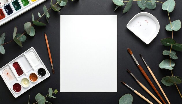 Art supplies frame a blank sheet on a dark surface - Powered by Adobe