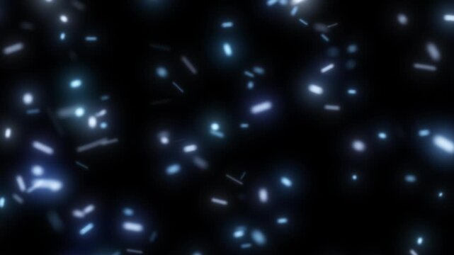 Abstract glowing blue light particles floating in darkness