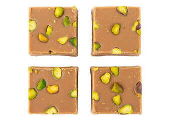 Isolated sweets chocolate nougat candies with pistachios, square shape, sweet snack, top view