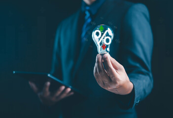 businessman holding a glowing light bulb with percentage icons symbolizes financial growth, interest rate strategy, and investment ideas, representing innovation in modern business economic planning.